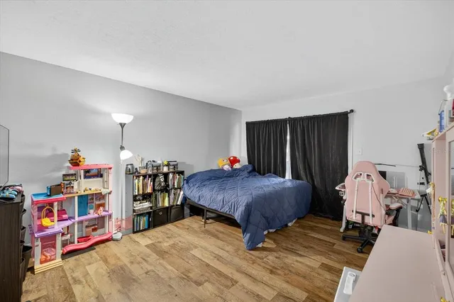 a bedroom with furniture and a book shelf