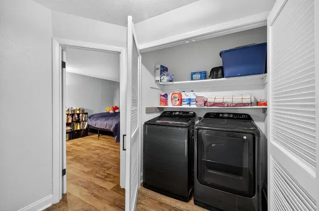 a utility room with closet dryer and washer