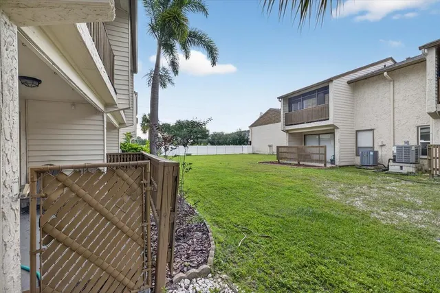 swimming pool with an outdoor seating and house in the background