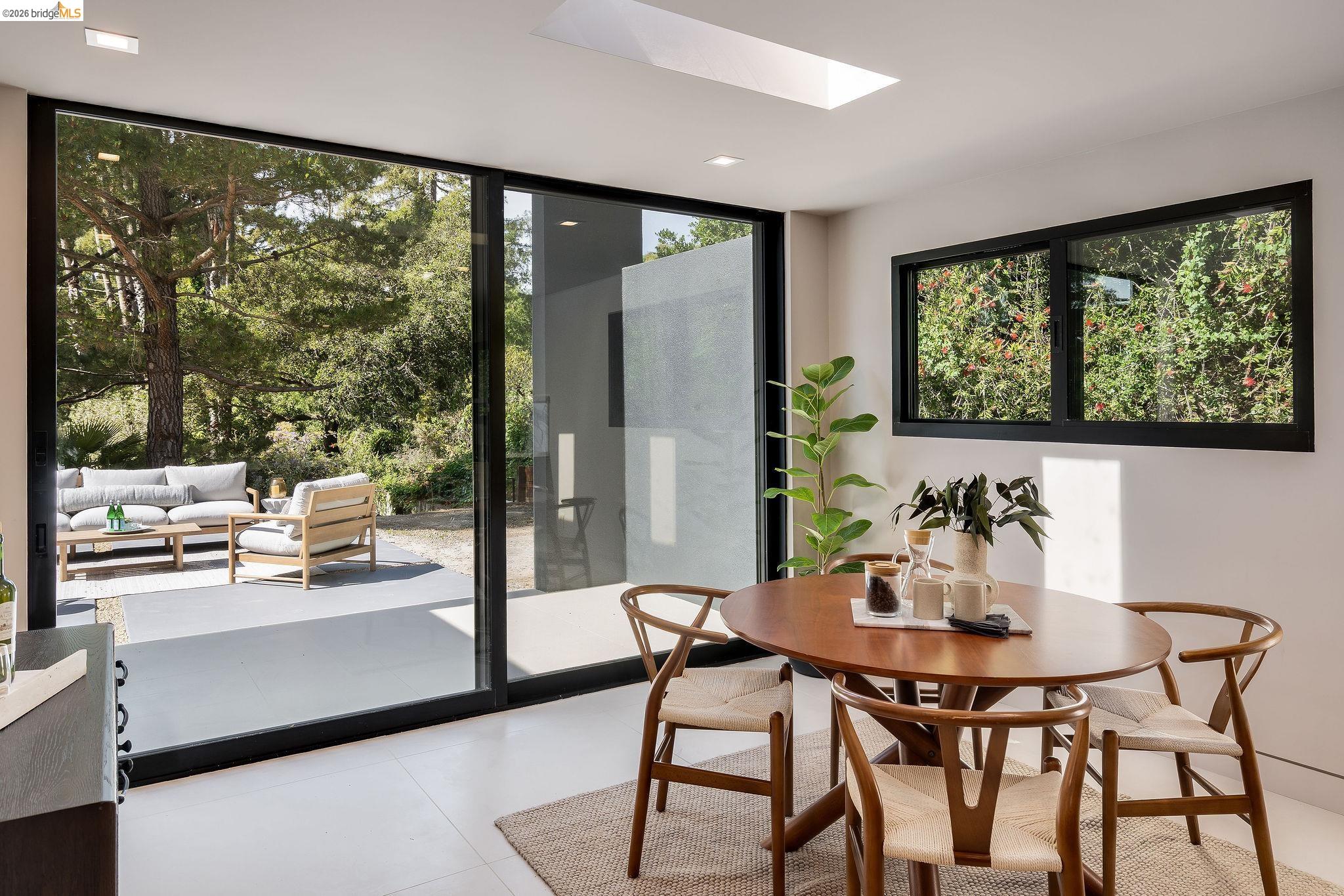 5645 Bacon Road Oakland, CA 94619 - Photo 38 of 94 Dining area featuring large sliding glass doors, a skylight, and recessed lighting
