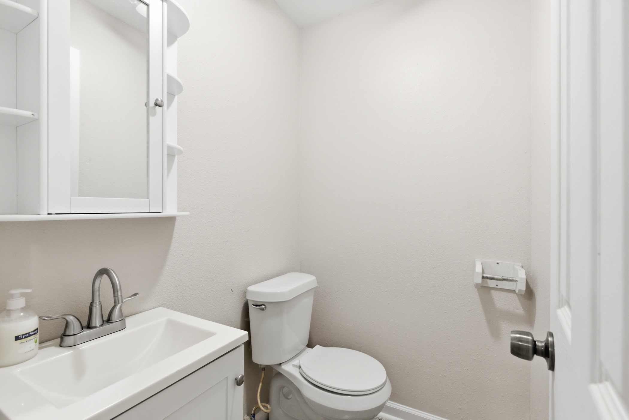 313 Grand Avenue Bacliff, TX 77518 - Photo 12 of 50 a bathroom with a toilet sink and mirror