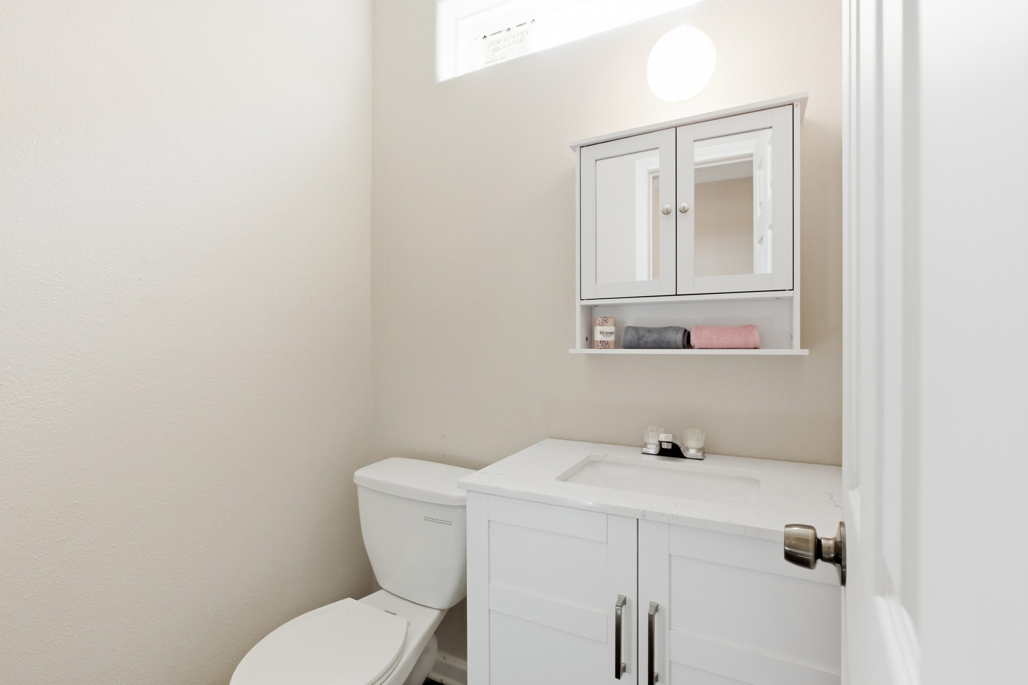 313 Grand Avenue Bacliff, TX 77518 - Photo 13 of 50 a bathroom with a toilet sink and mirror
