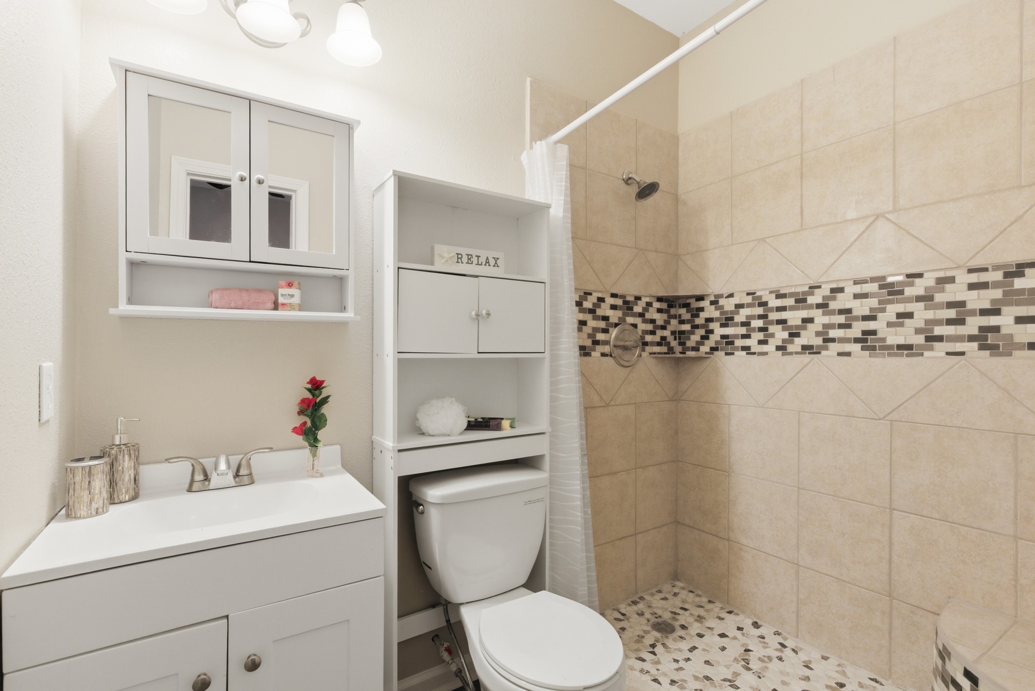 313 Grand Avenue Bacliff, TX 77518 - Photo 15 of 50 a bathroom with a toilet a sink and a shower