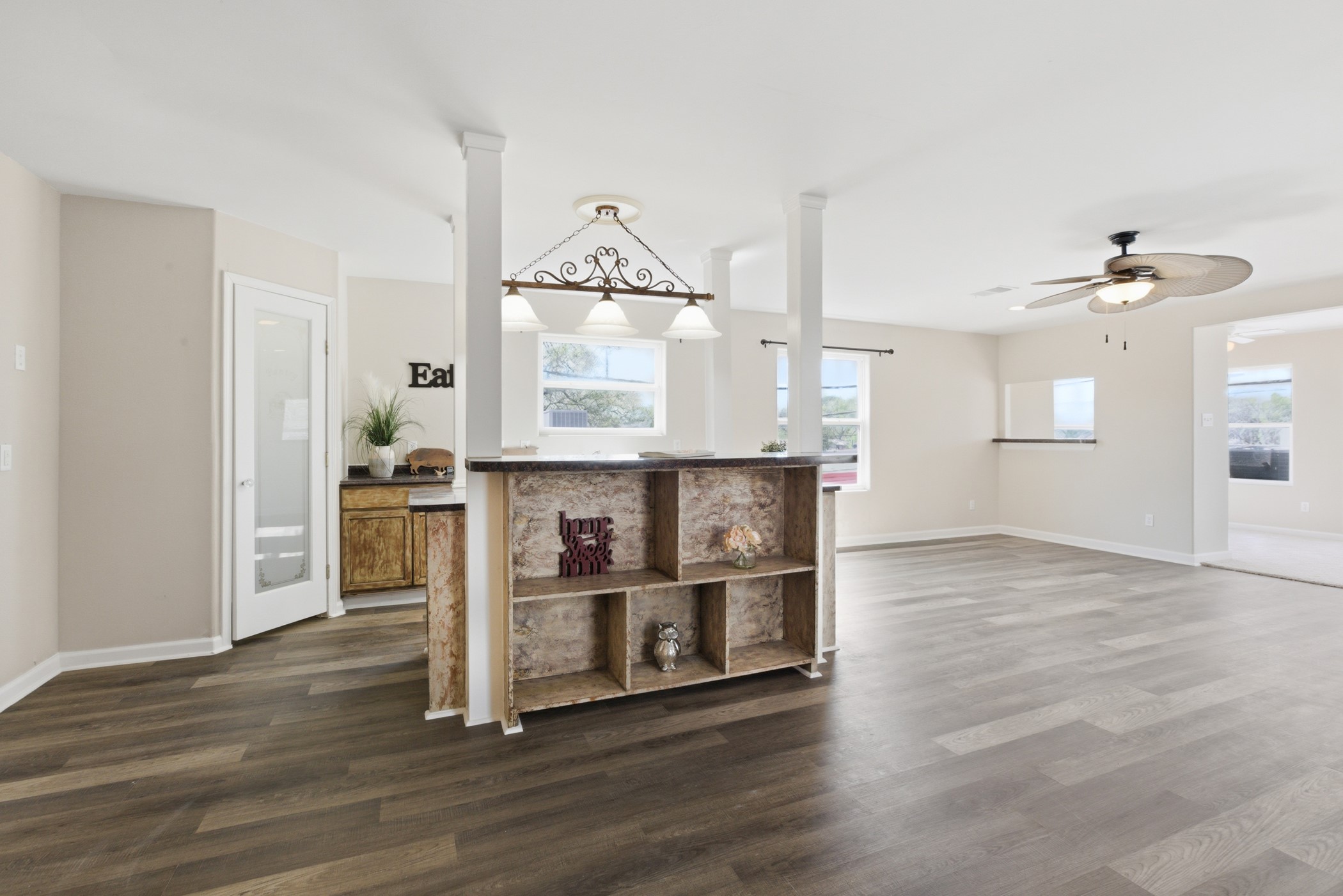 313 Grand Avenue Bacliff, TX 77518 - Photo 24 of 50 a view of kitchen and empty room with wooden floor