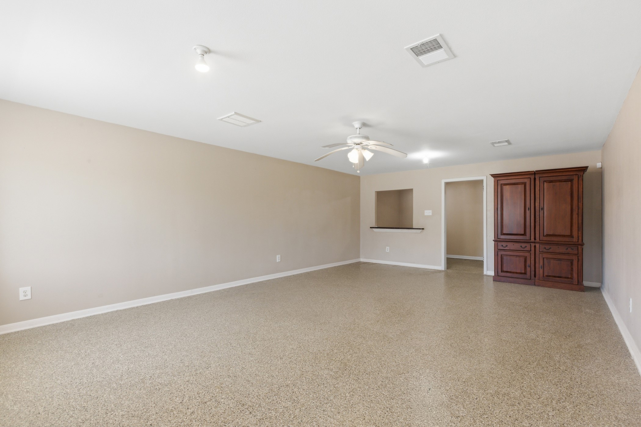 313 Grand Avenue Bacliff, TX 77518 - Photo 8 of 50 an empty room with chandelier fan and windows
