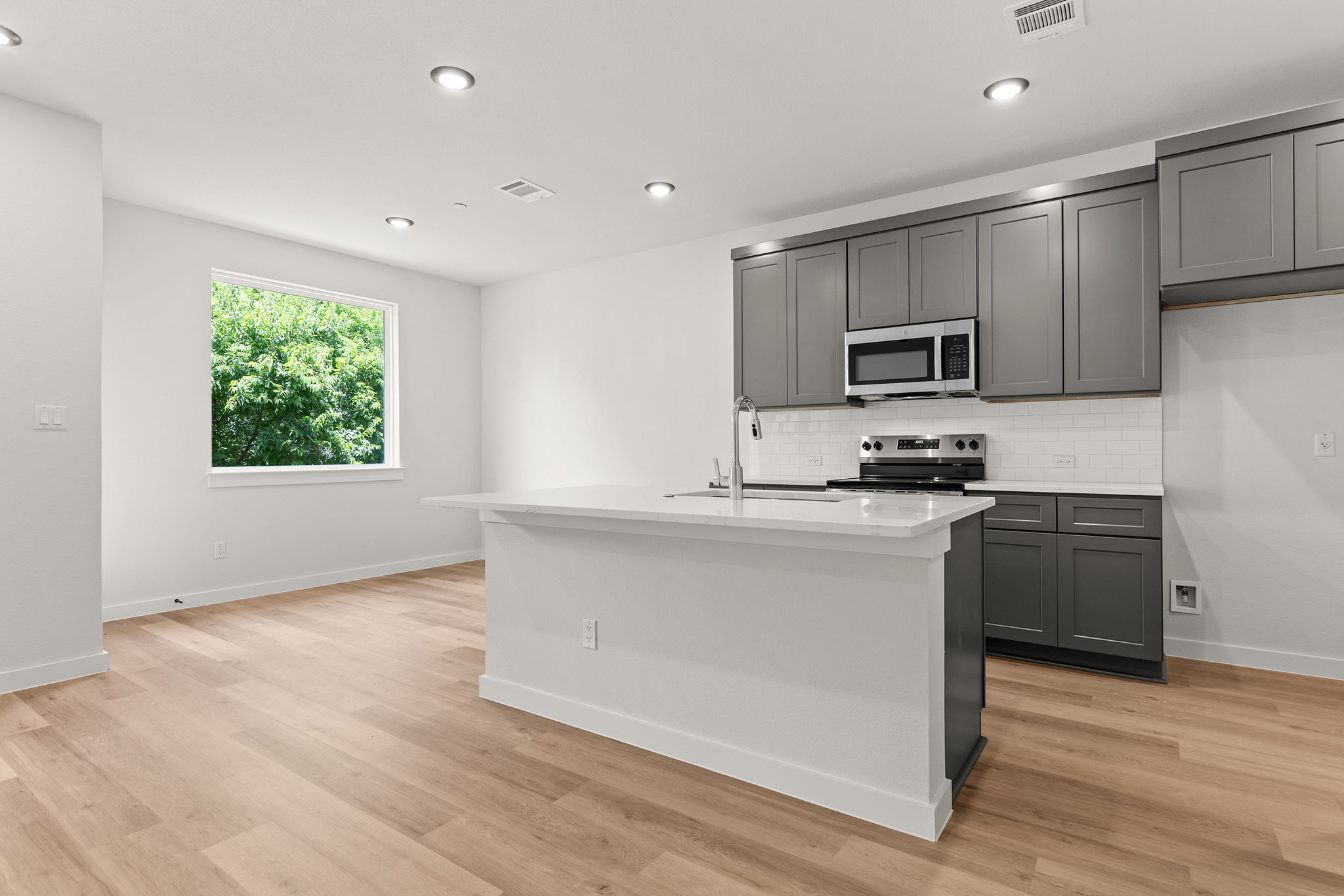 2600 Gattis School Road, Unit 1002 Round Rock, TX 78664 - Photo 7 of 40 A sleek island kitchen provides ample space for culinary creations and casual dining.