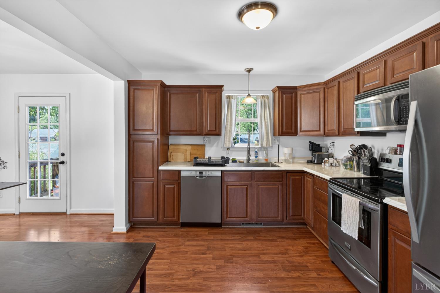 1305 Harding Street Lynchburg, VA 24502 - Photo 7 of 33 a kitchen with stainless steel appliances granite countertop a stove sink and cabinets