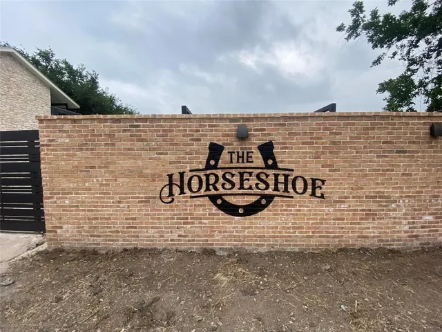 a view of a brick wall next to a building