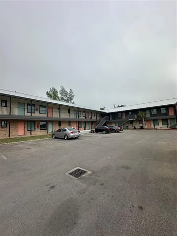 a view of a car is parked in front of a building