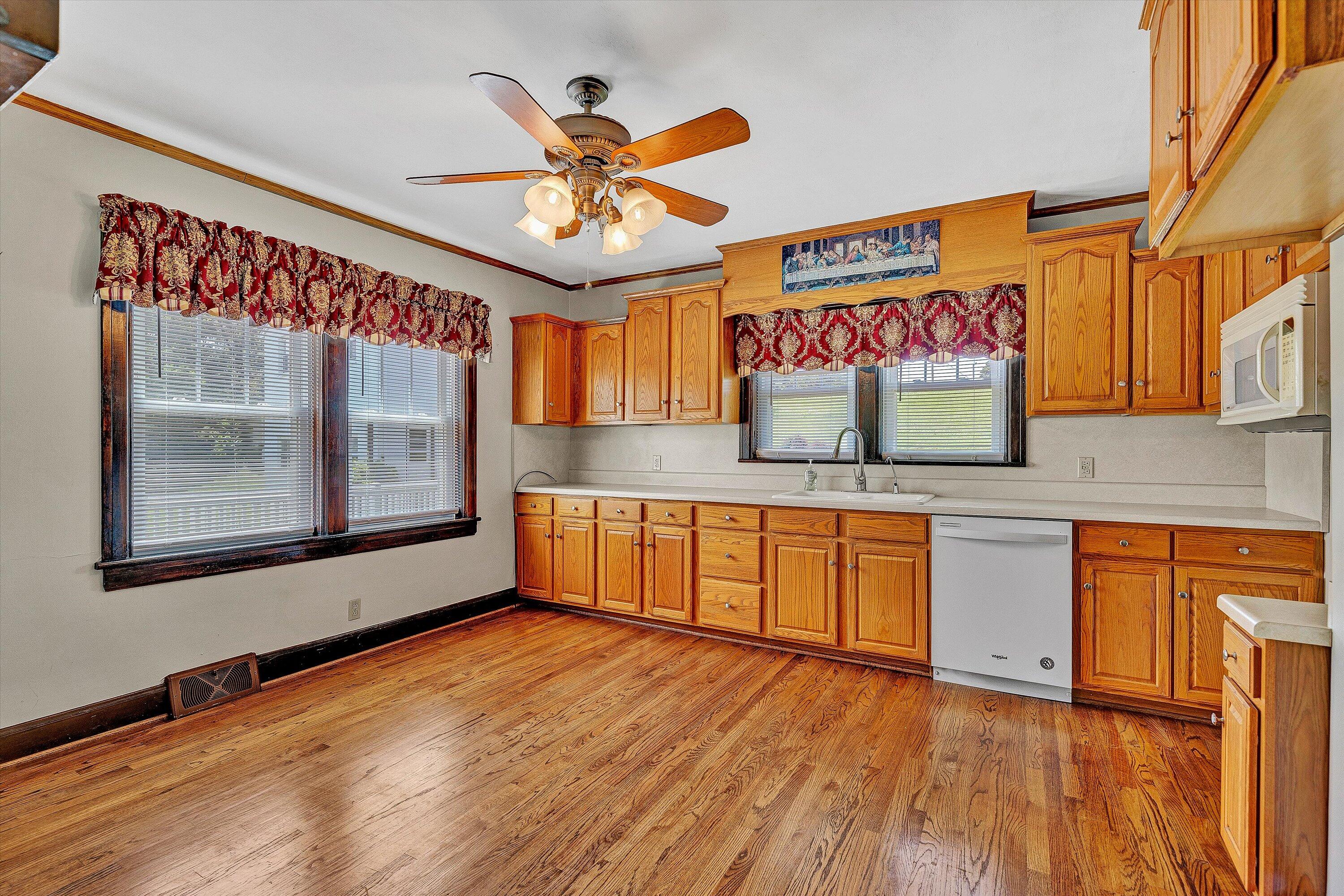 77 Mountain Pass Road Blue Ridge, VA 24064 - Photo 11 of 42 a view of a kitchen with stainless steel appliances wooden floor and a large window