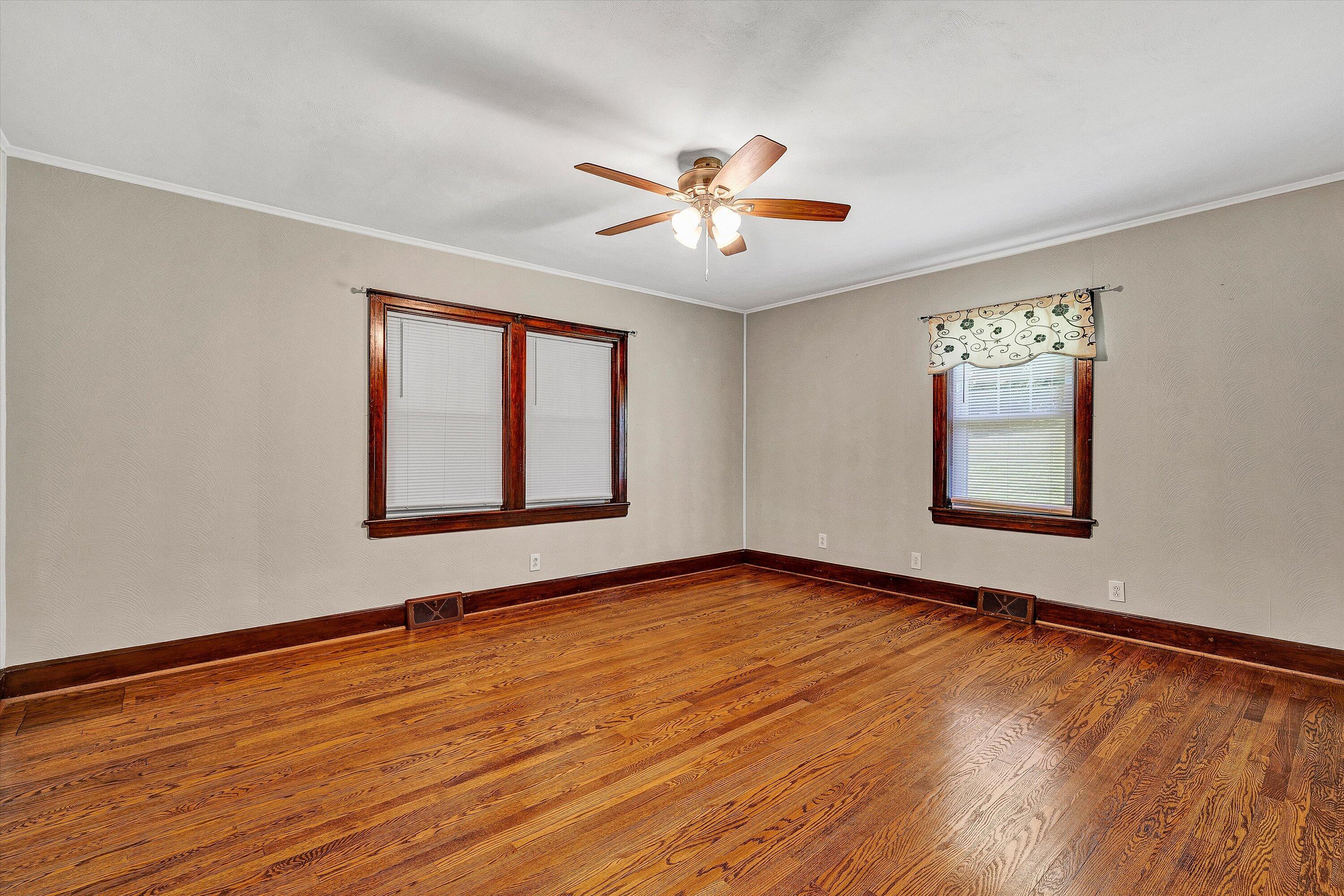 77 Mountain Pass Road Blue Ridge, VA 24064 - Photo 15 of 42 a view of an empty room with window and wooden floor