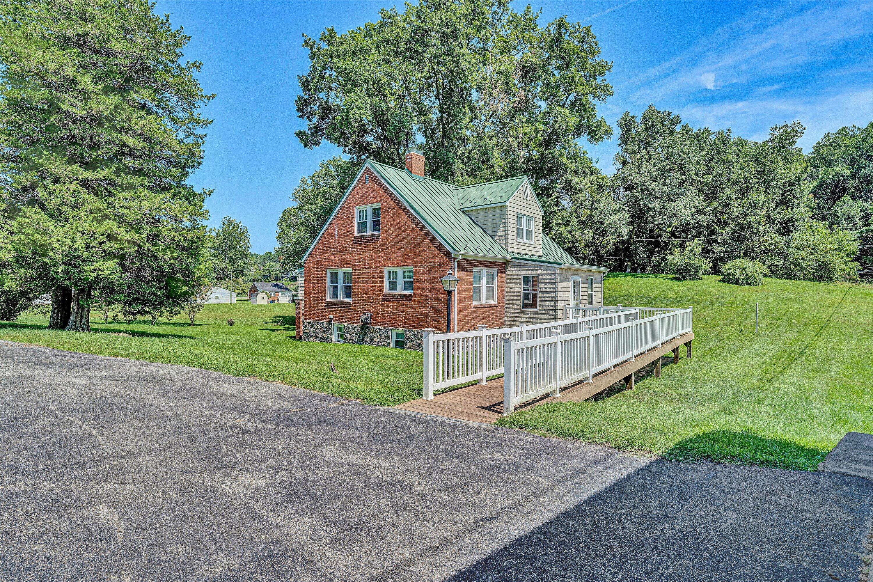 77 Mountain Pass Road Blue Ridge, VA 24064 - Photo 2 of 42 a front view of a house with a yard