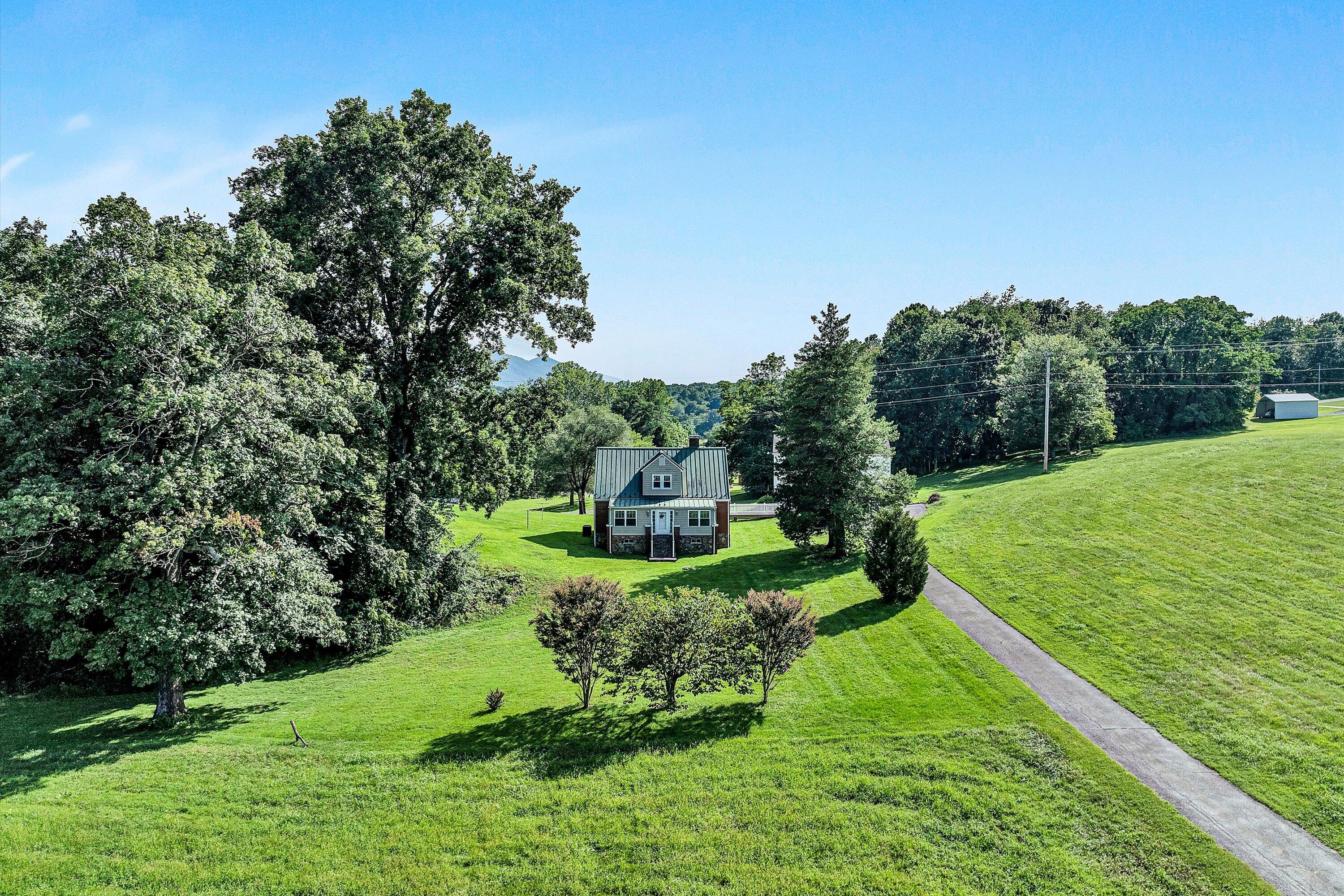 77 Mountain Pass Road Blue Ridge, VA 24064 - Photo 40 of 42 a view of a garden with large trees