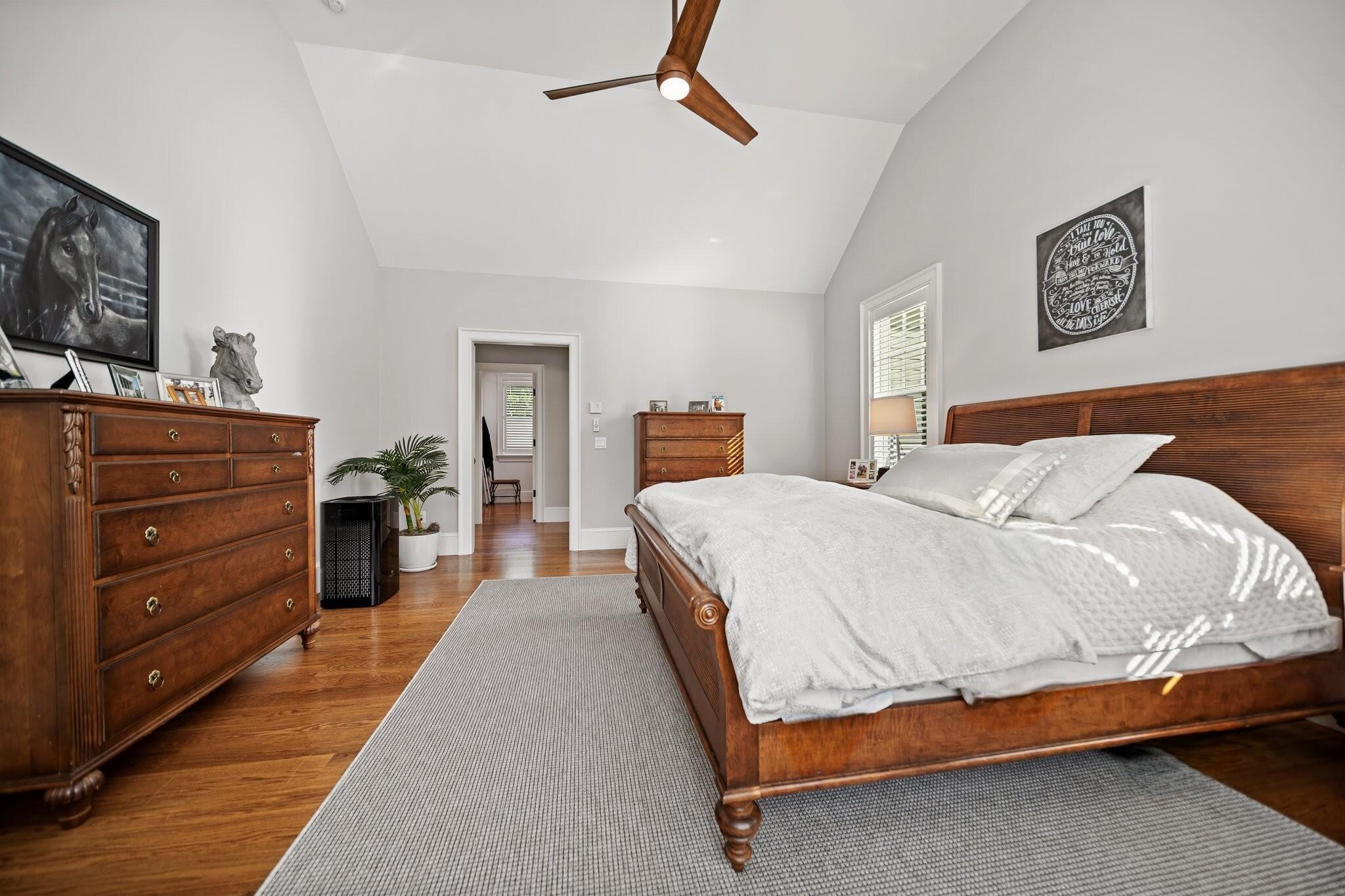 444 Vineyard Road Cotuit, MA 02635 - Photo 15 of 59 a bedroom with a bed and wooden floor