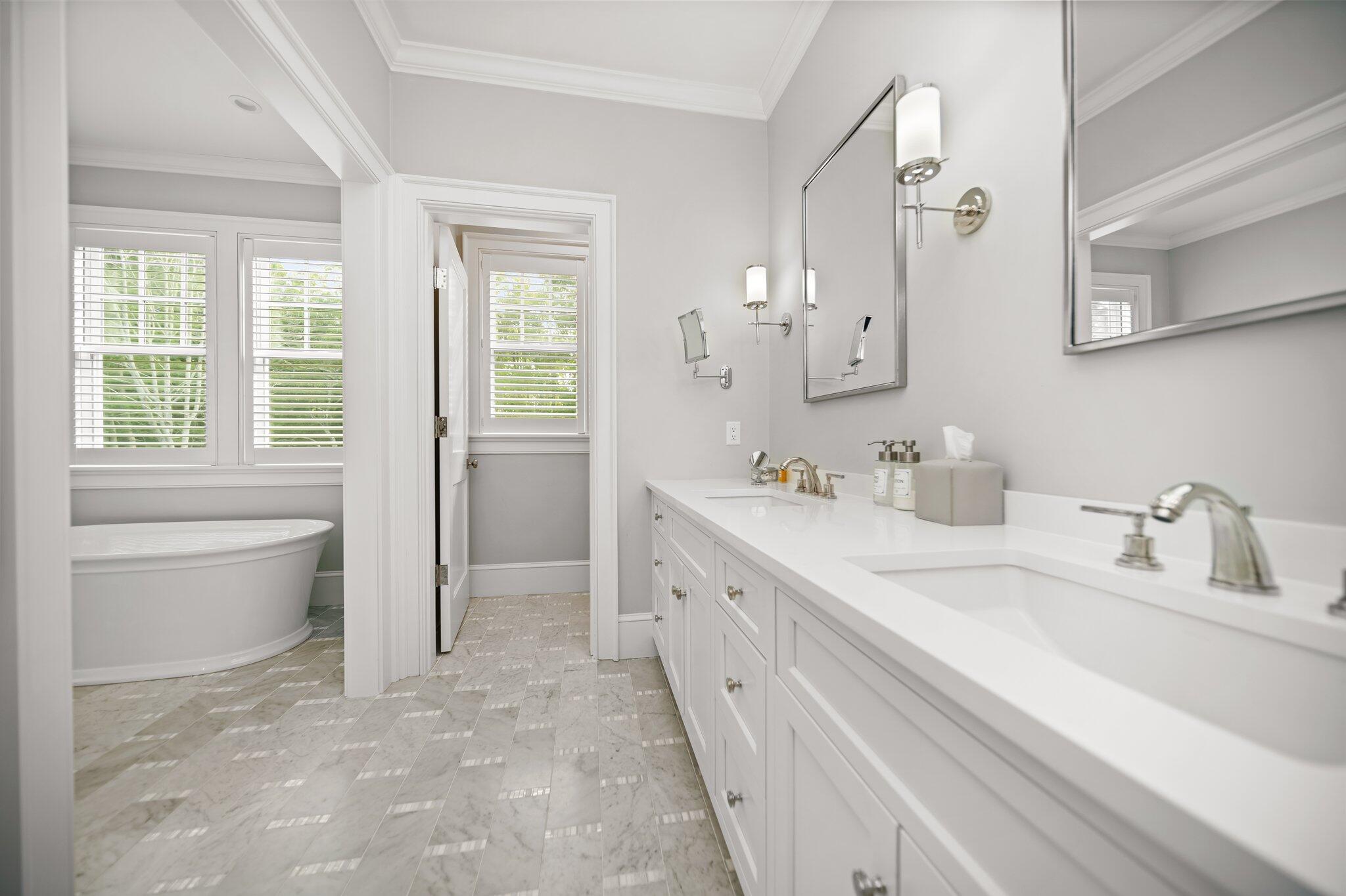 444 Vineyard Road Cotuit, MA 02635 - Photo 18 of 59 a spacious bathroom with a double vanity sink a mirror and a bathtub