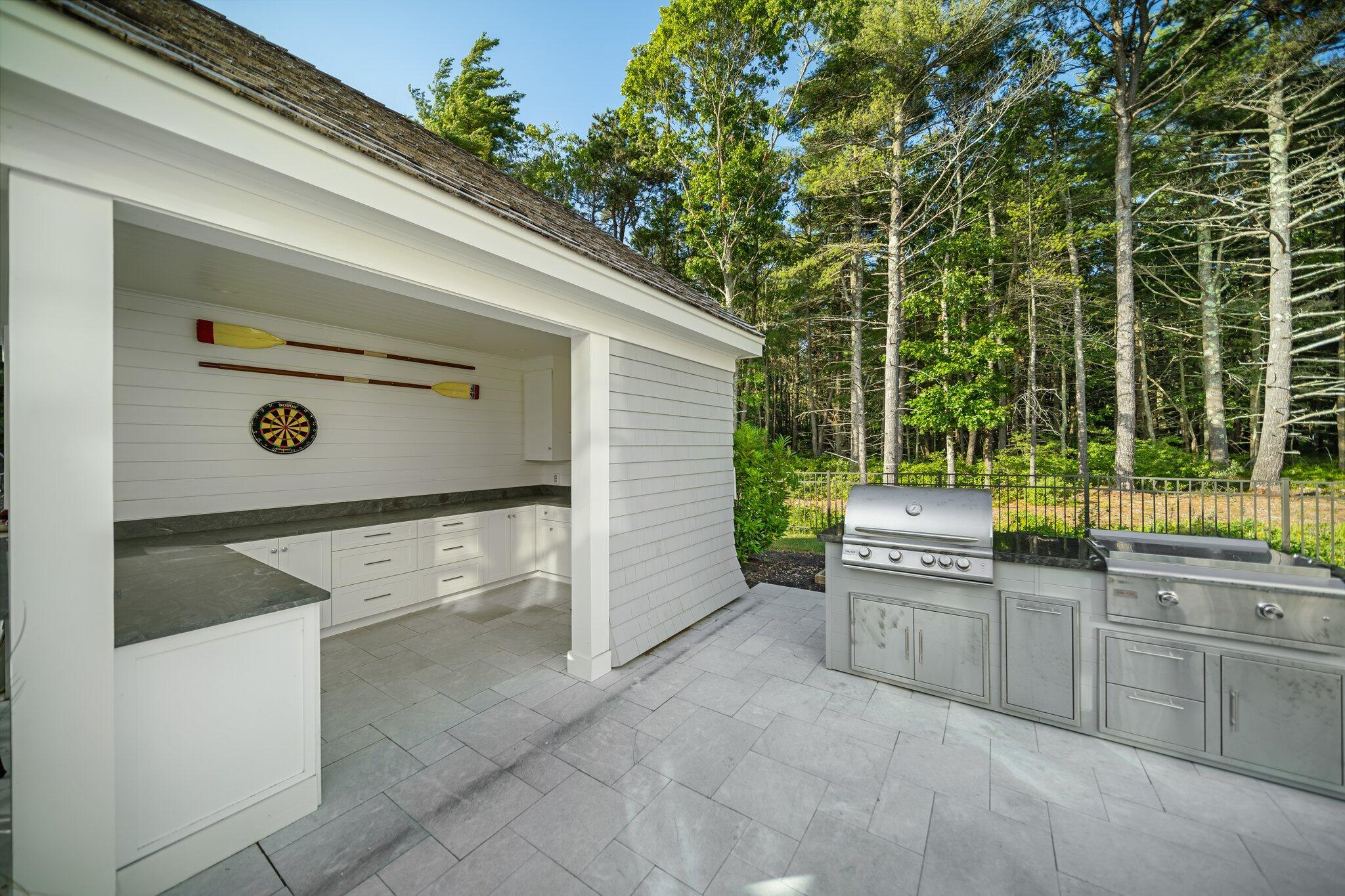 444 Vineyard Road Cotuit, MA 02635 - Photo 22 of 59 a view of a kitchen with a sink and dishwasher a barbeque oven with wooden fence