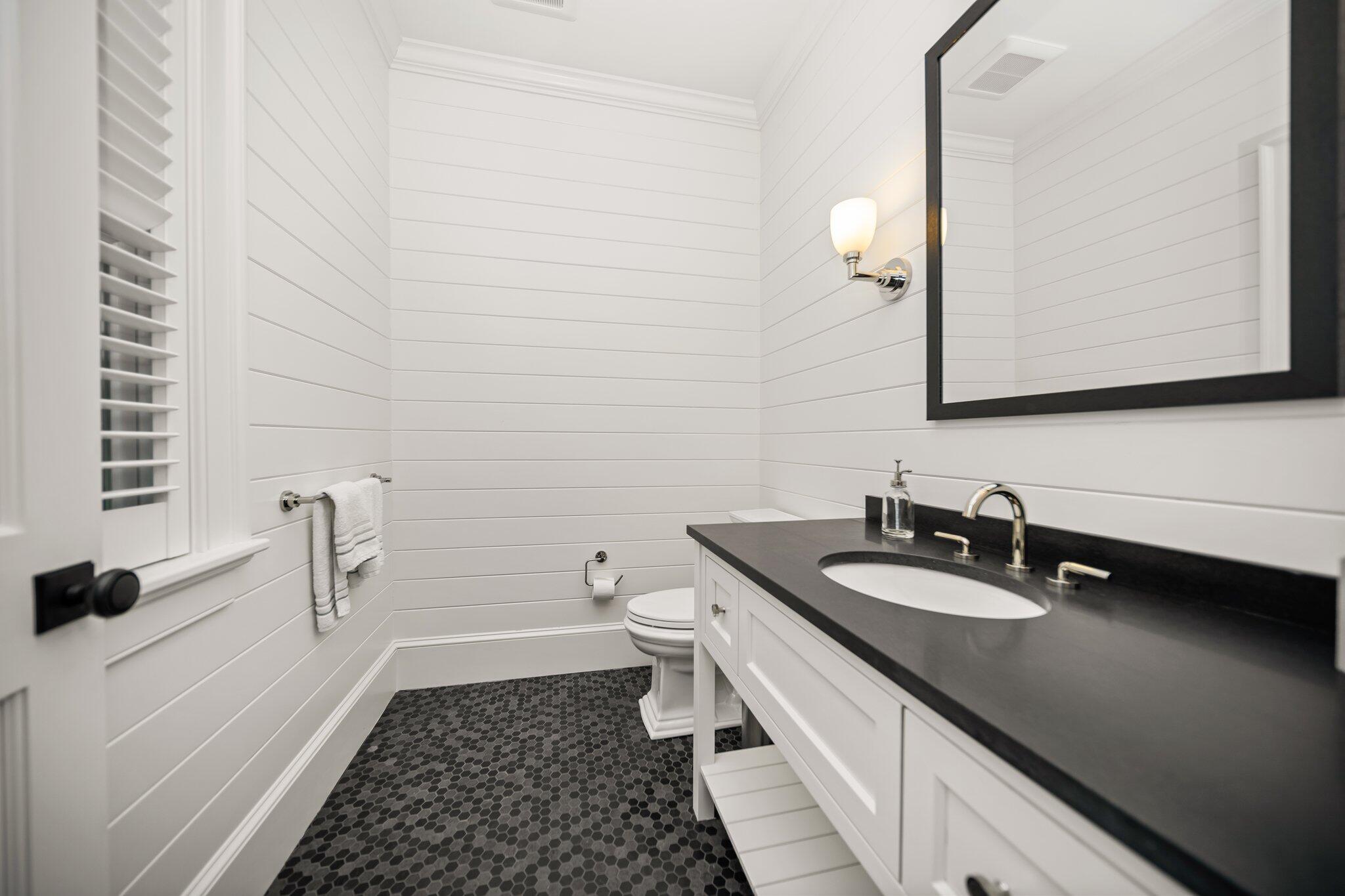 444 Vineyard Road Cotuit, MA 02635 - Photo 31 of 59 a bathroom with a double vanity sink a toilet and a mirror