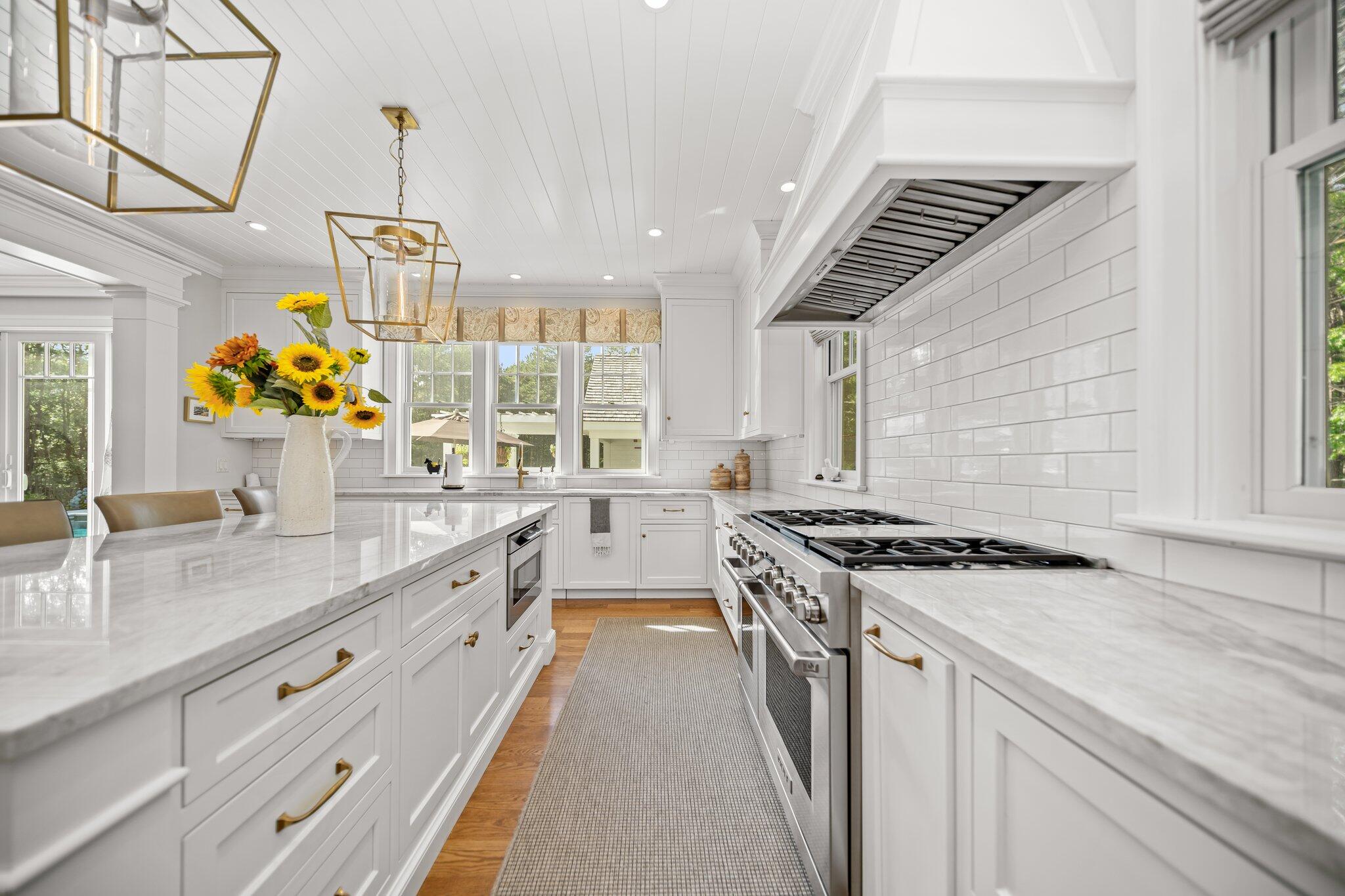 444 Vineyard Road Cotuit, MA 02635 - Photo 32 of 59 a kitchen with stainless steel appliances granite countertop a sink stove and cabinets