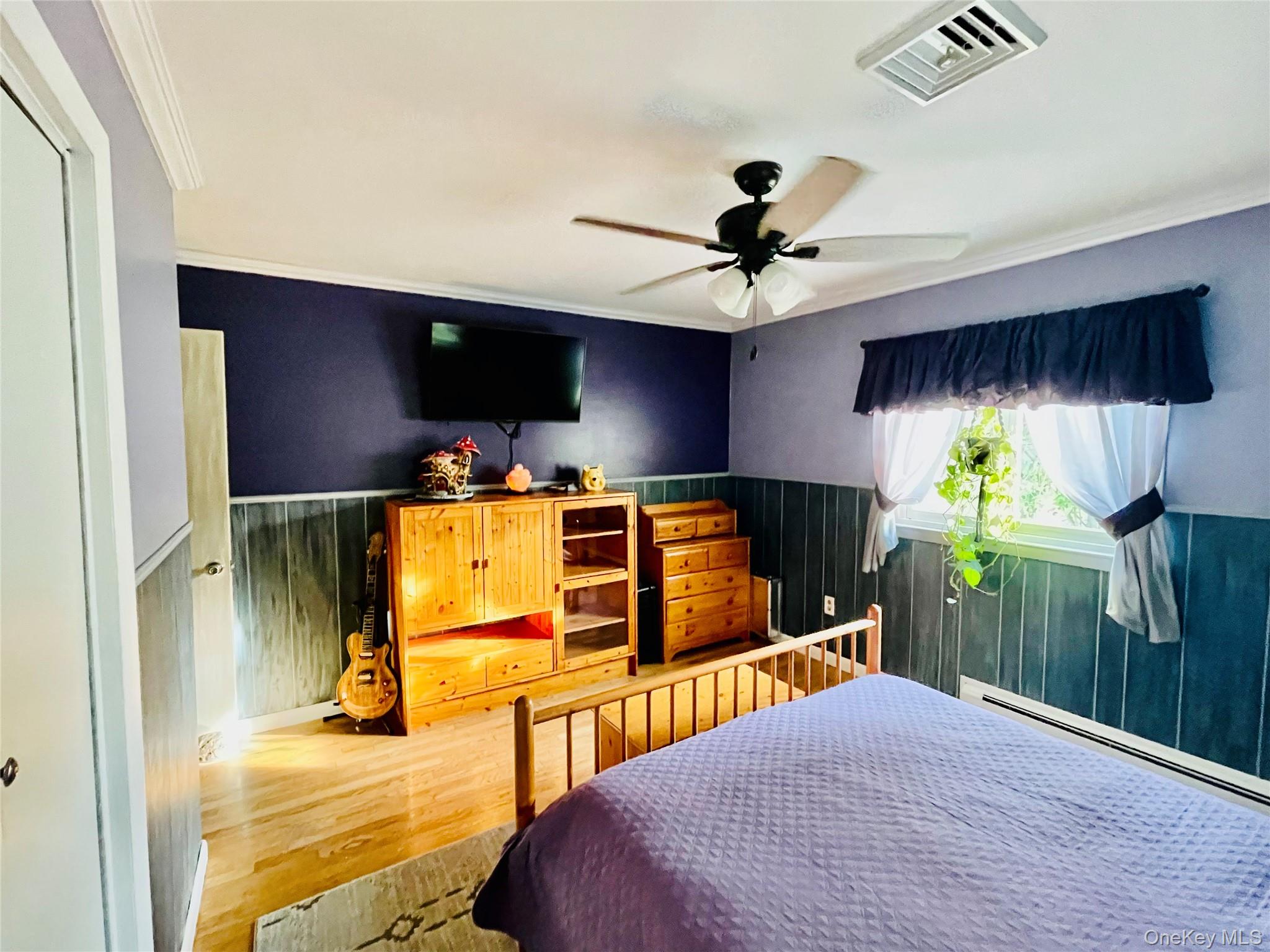 137 Cross Road Goshen, NY 10924 - Photo 17 of 50 a bedroom with a bed and a chandelier