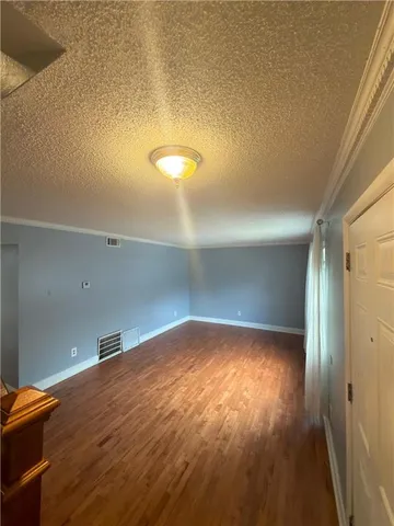 a view of a room with wooden floor and chair
