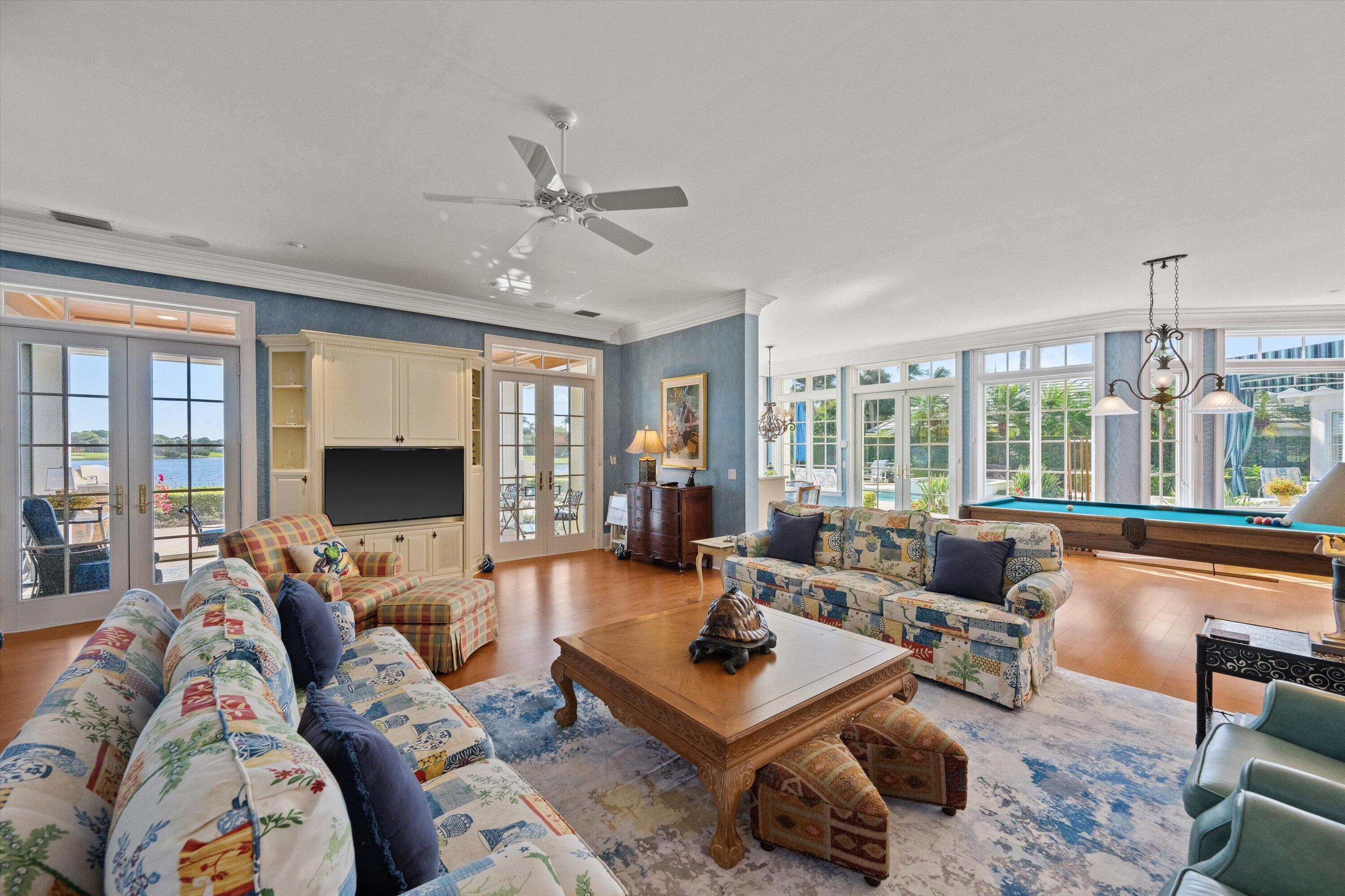 258 Locha Drive Jupiter, FL 33458 - Photo 13 of 76 a living room with furniture a flat screen tv and a large window