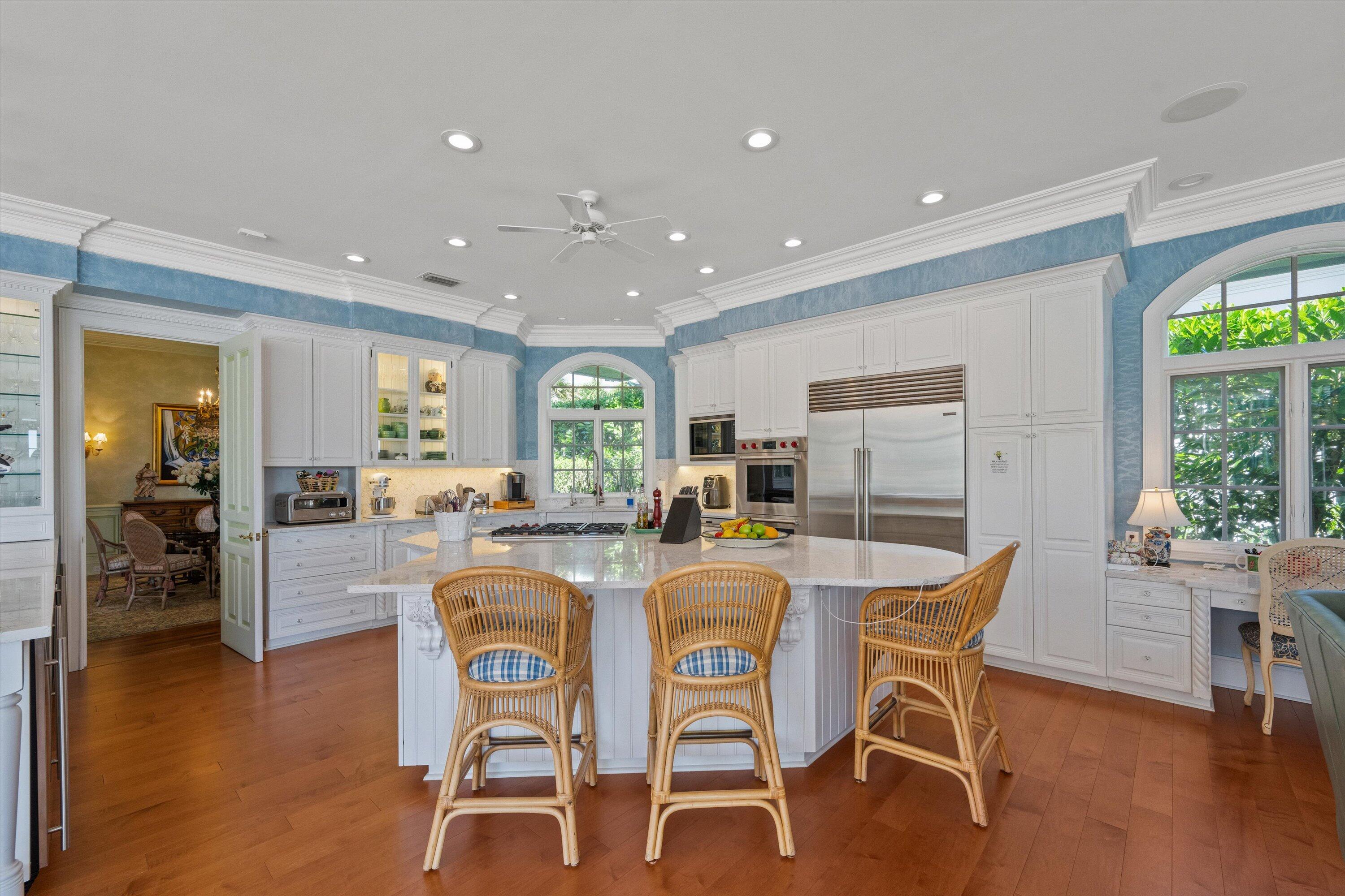 258 Locha Drive Jupiter, FL 33458 - Photo 18 of 76 a dining room with furniture a window and wooden floor