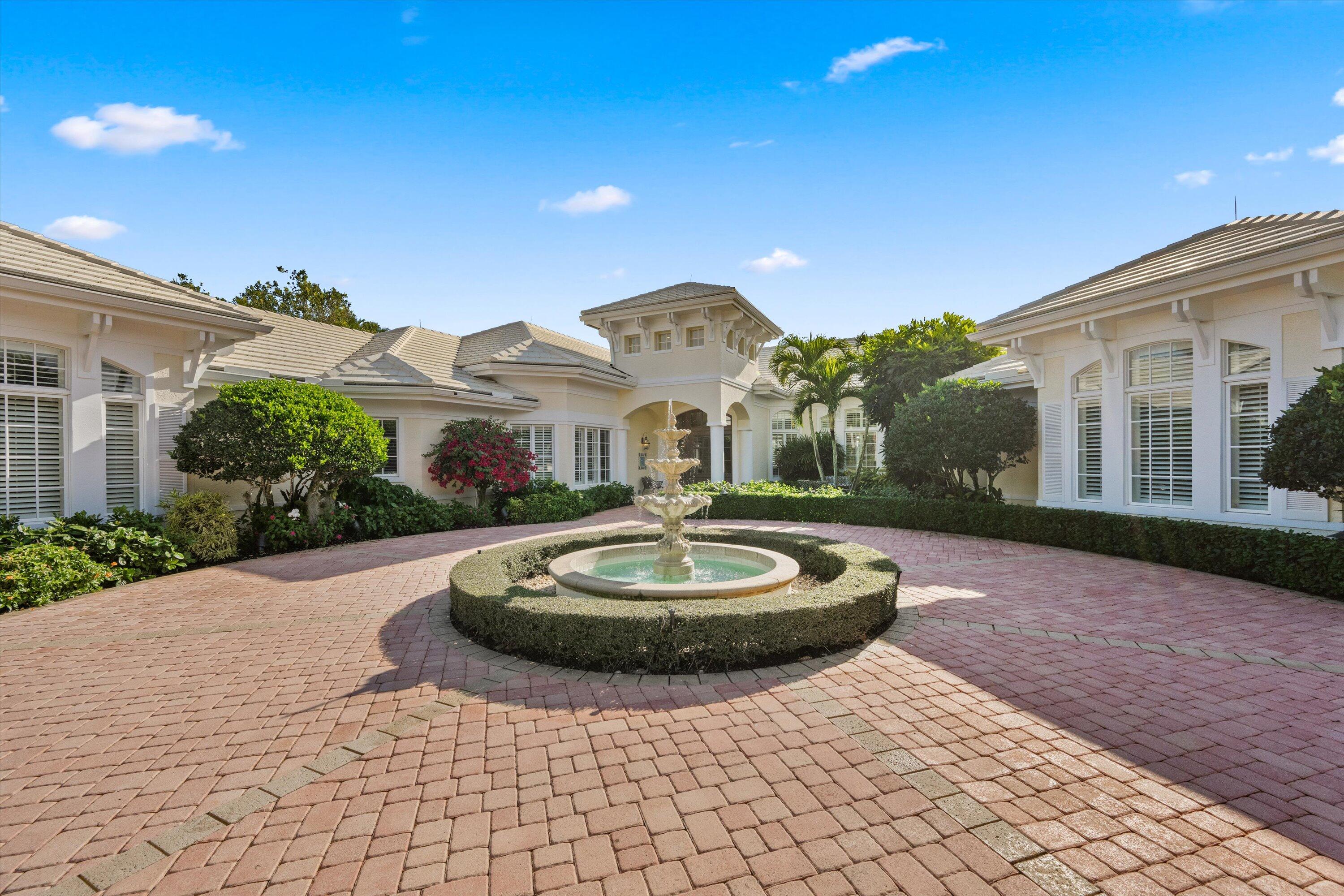 258 Locha Drive Jupiter, FL 33458 - Photo 2 of 76 a front view of a house with a yard