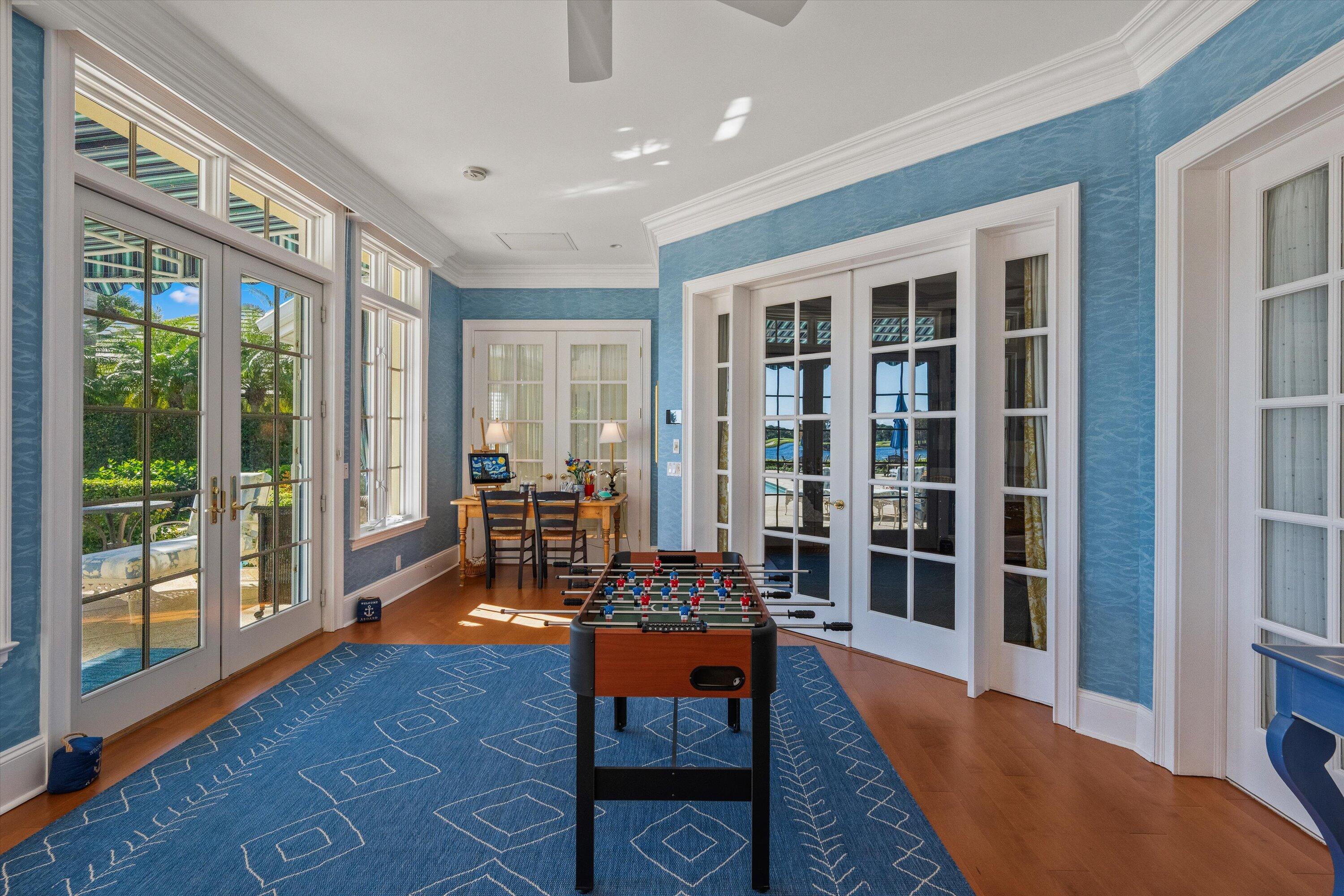 258 Locha Drive Jupiter, FL 33458 - Photo 24 of 76 a living room with furniture a large window and wooden floor