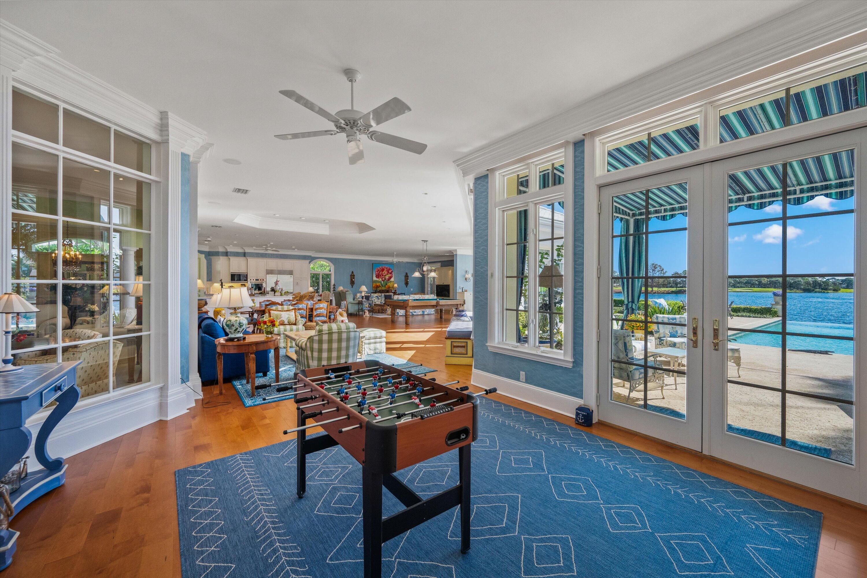 258 Locha Drive Jupiter, FL 33458 - Photo 25 of 76 a living room filled with furniture and a book shelf