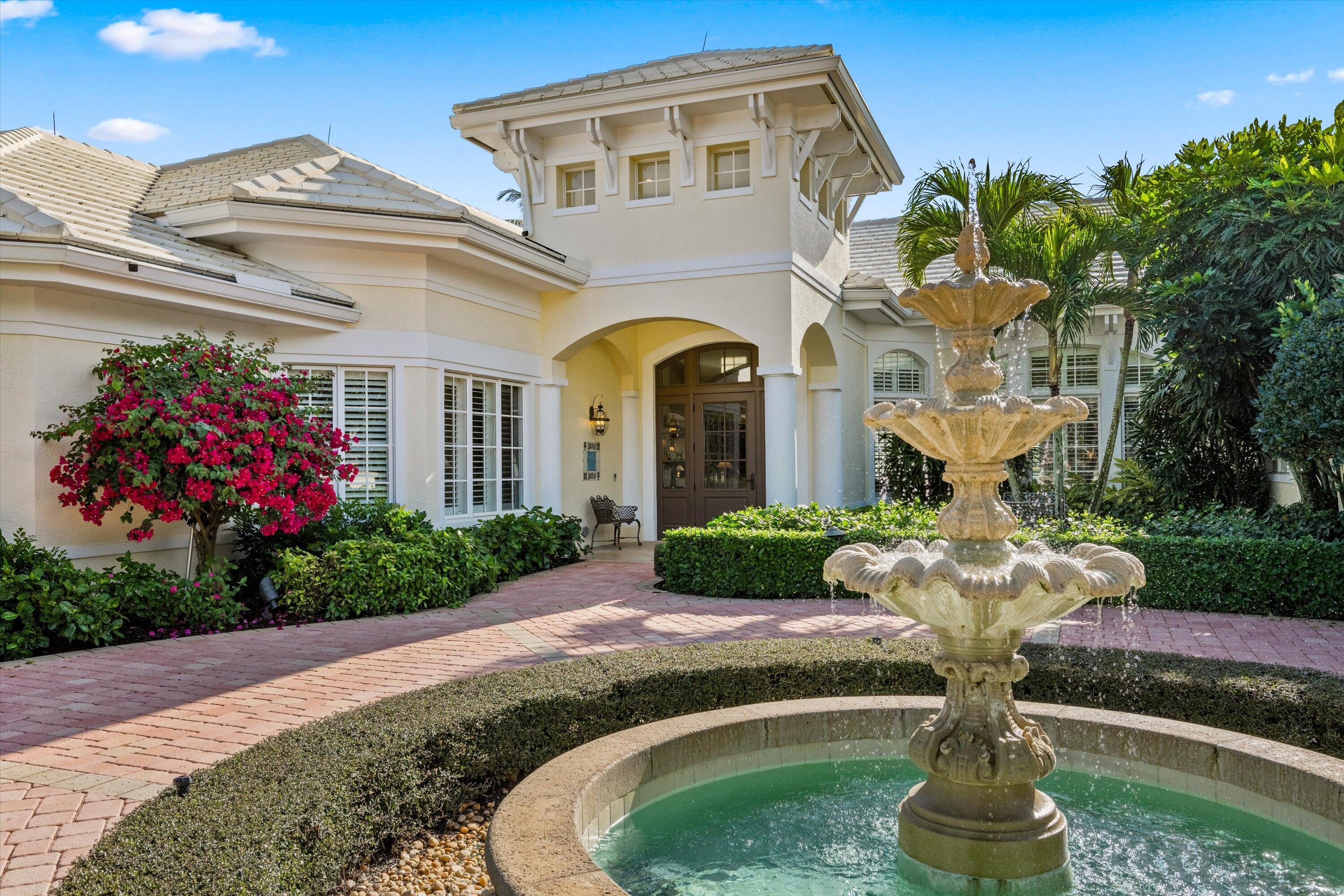 258 Locha Drive Jupiter, FL 33458 - Photo 4 of 76 a front view of a house with a yard