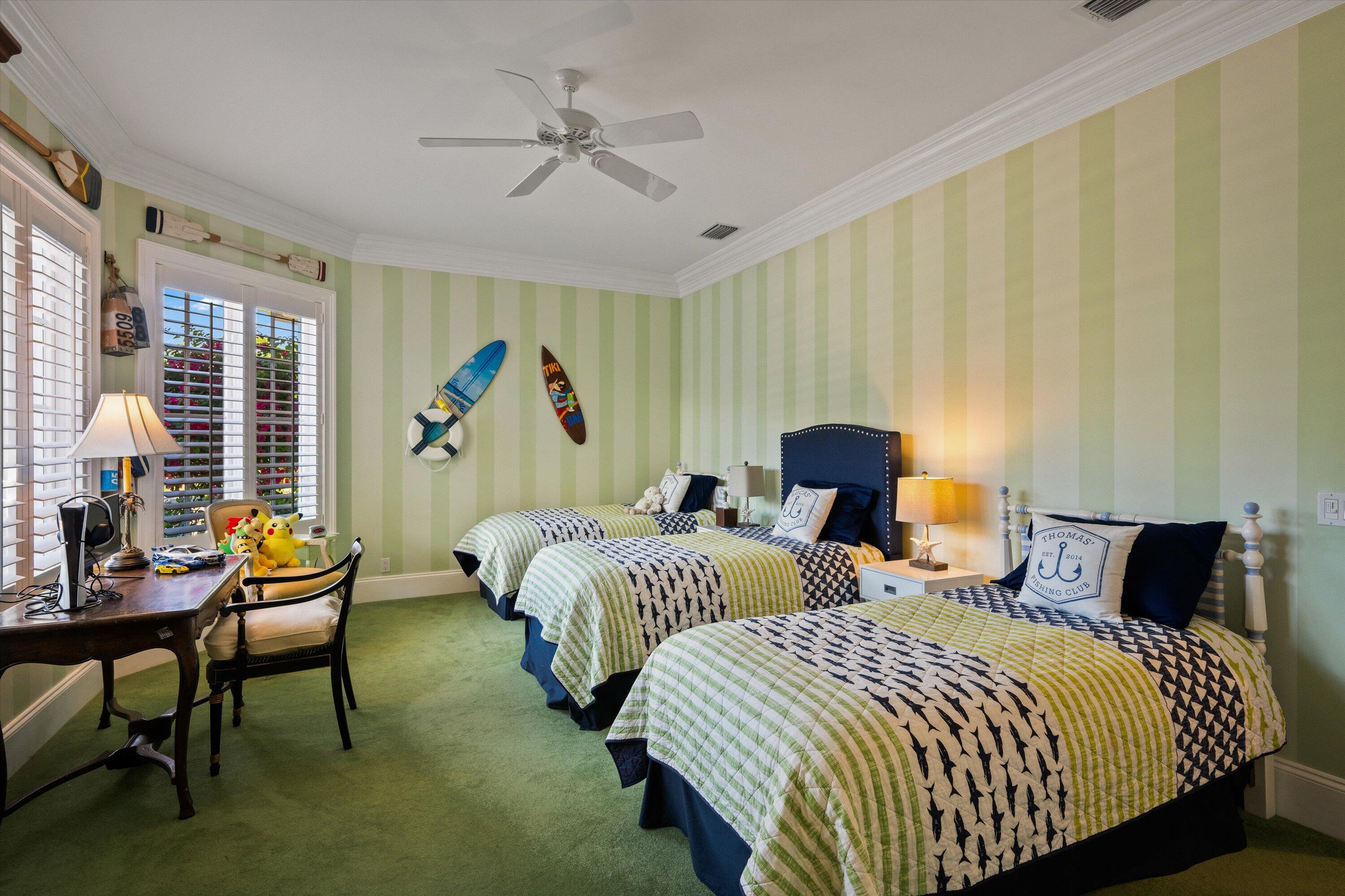 258 Locha Drive Jupiter, FL 33458 - Photo 43 of 76 a bedroom with two beds and a chandelier