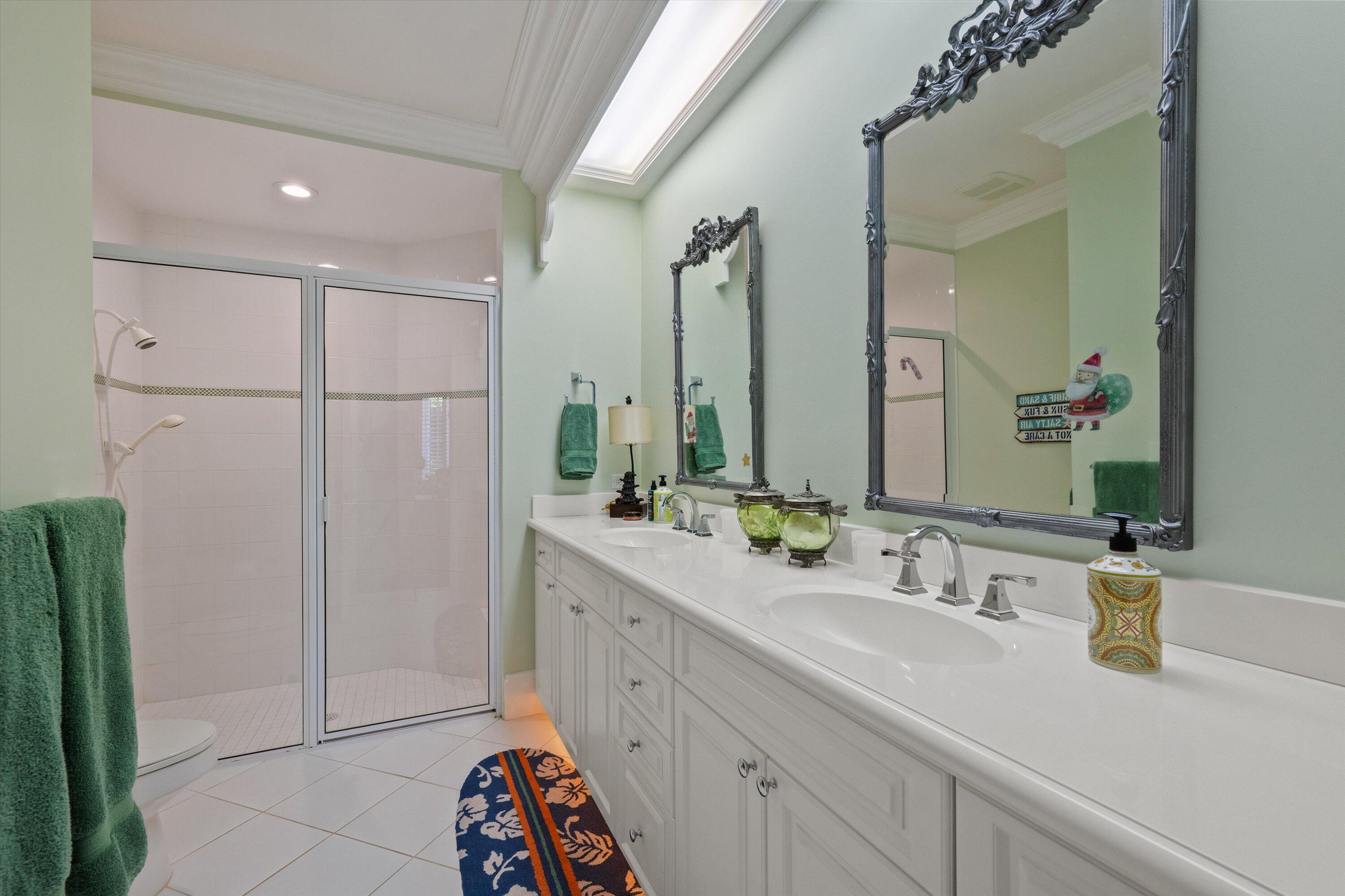 258 Locha Drive Jupiter, FL 33458 - Photo 44 of 76 a bathroom with a double vanity sink and mirror