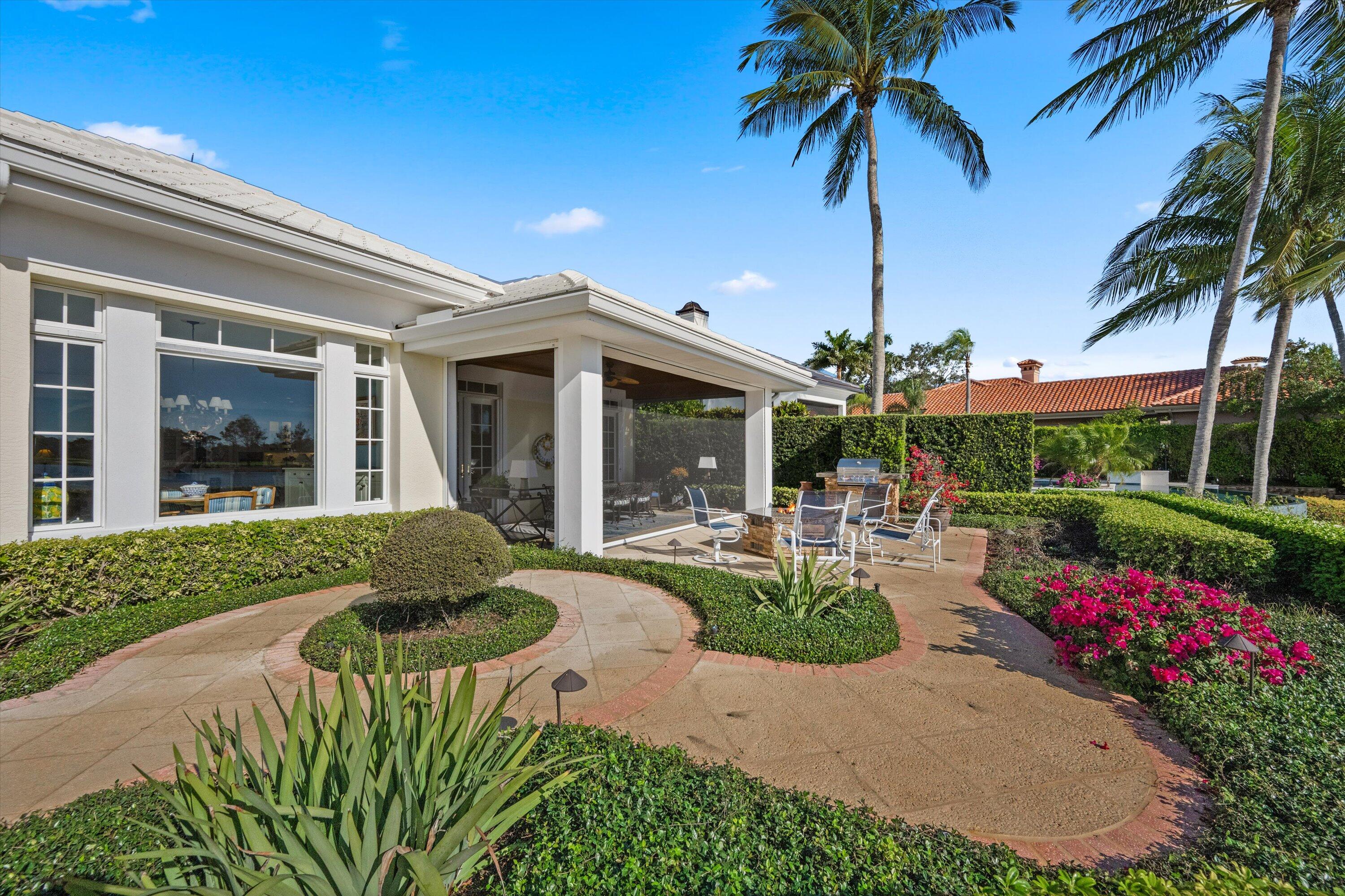 258 Locha Drive Jupiter, FL 33458 - Photo 56 of 76 a front view of a house with porch and garden