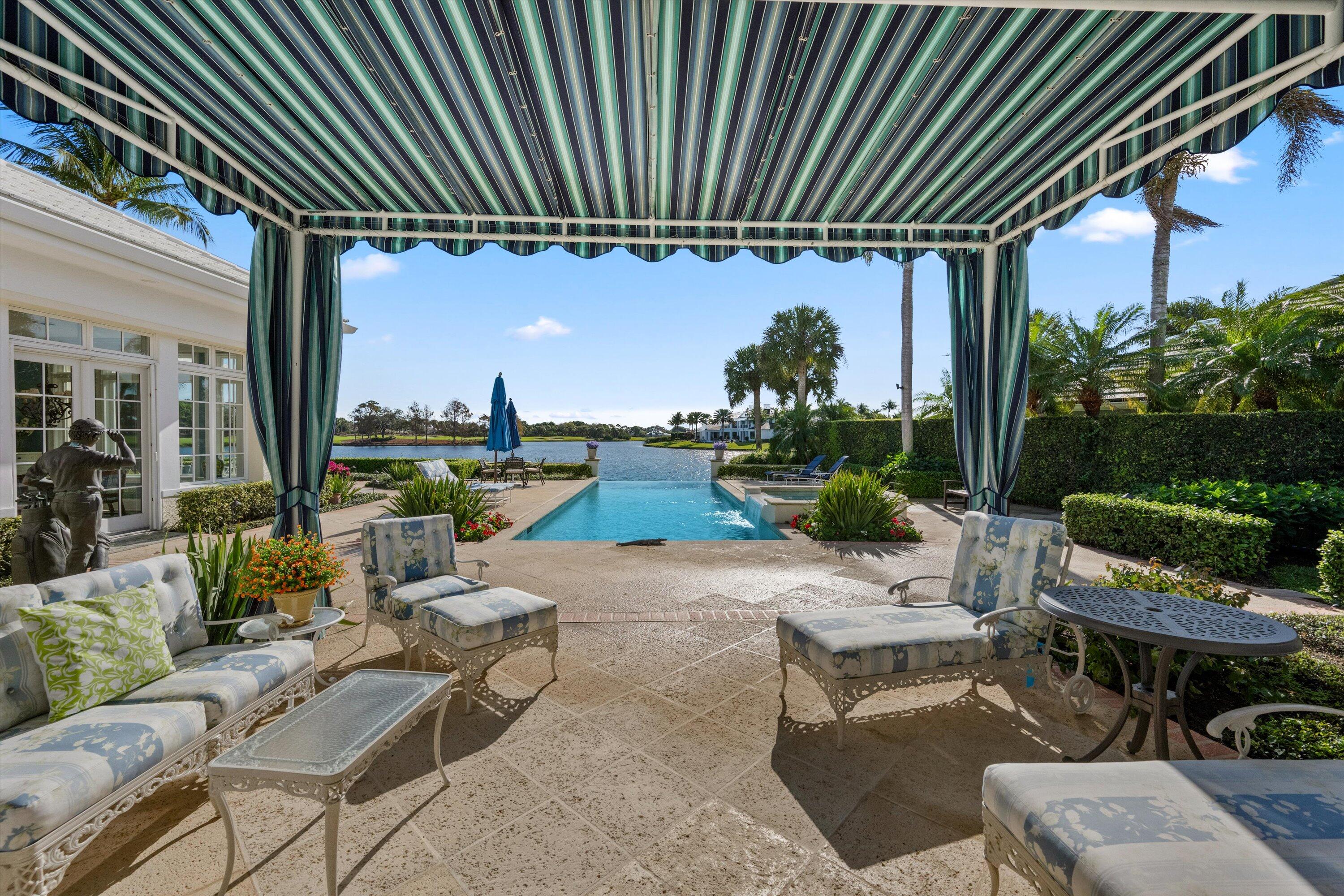 258 Locha Drive Jupiter, FL 33458 - Photo 59 of 76 a backyard of a house with outdoor seating