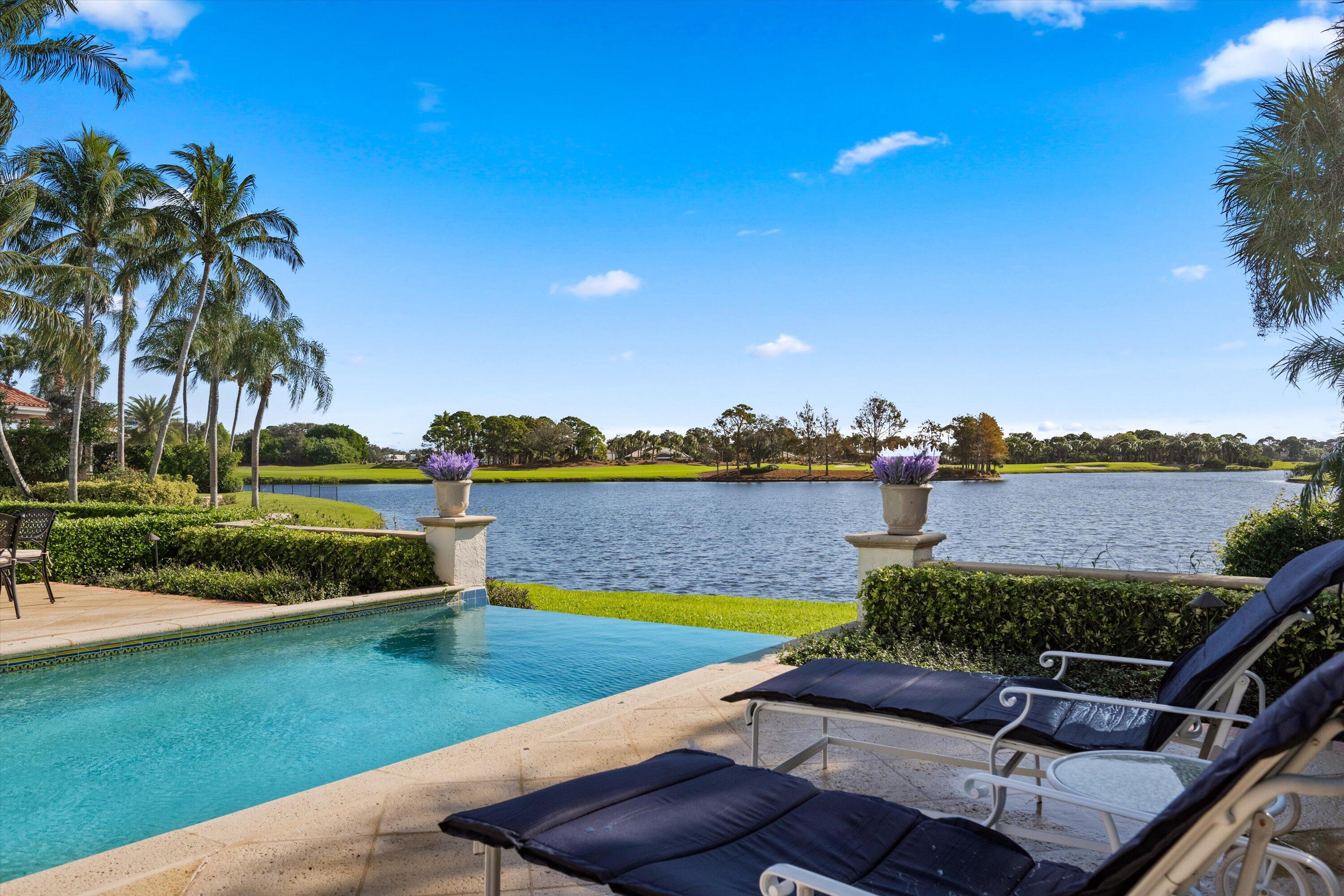 258 Locha Drive Jupiter, FL 33458 - Photo 63 of 76 a view of a swimming pool and lounge chairs in the patio