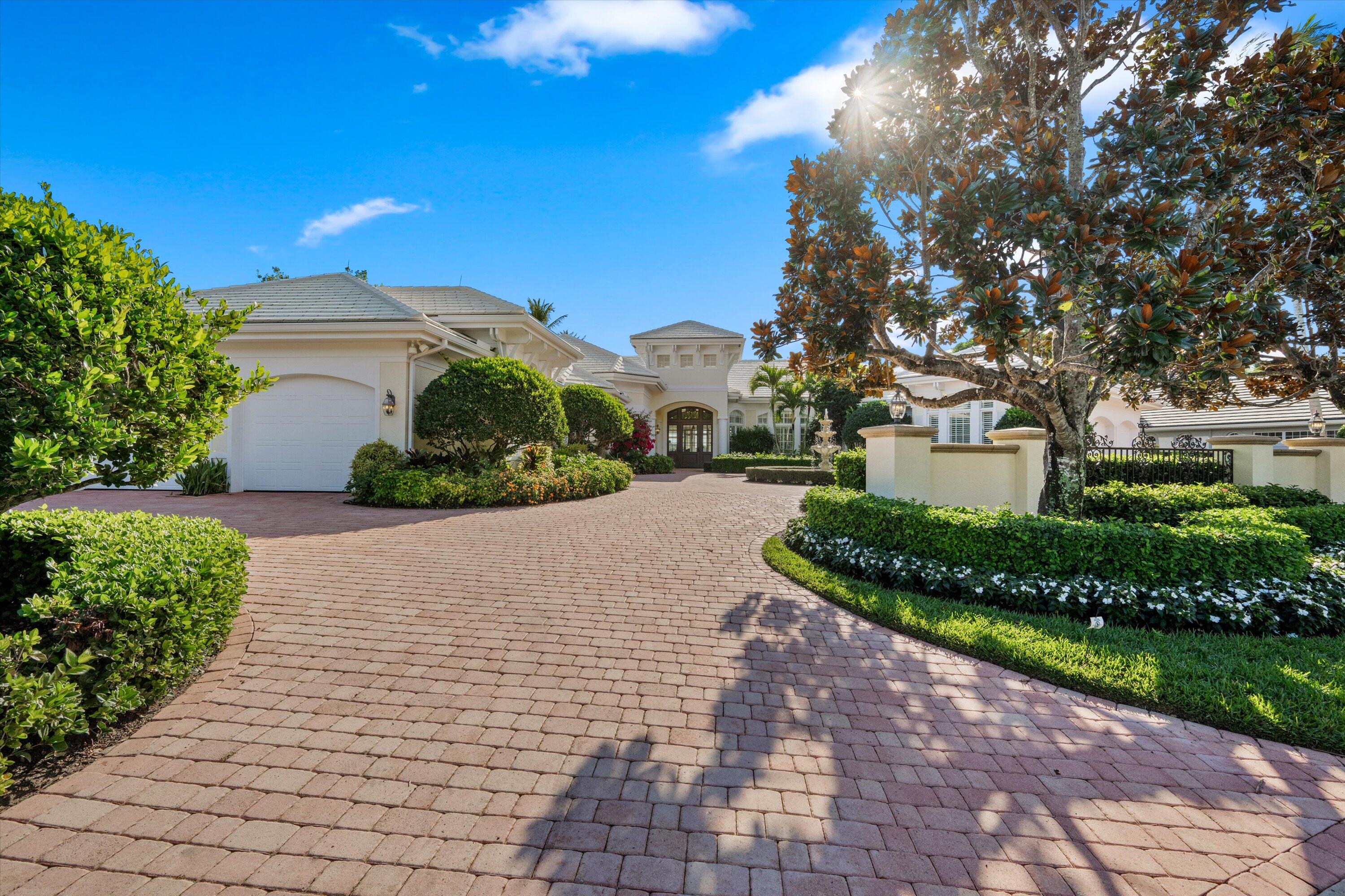258 Locha Drive Jupiter, FL 33458 - Photo 76 of 76 a view of a house with a yard and potted plants