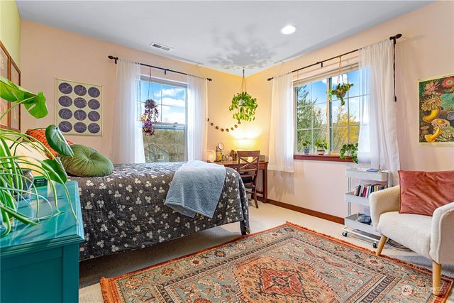 a bedroom with a bed and a dresser