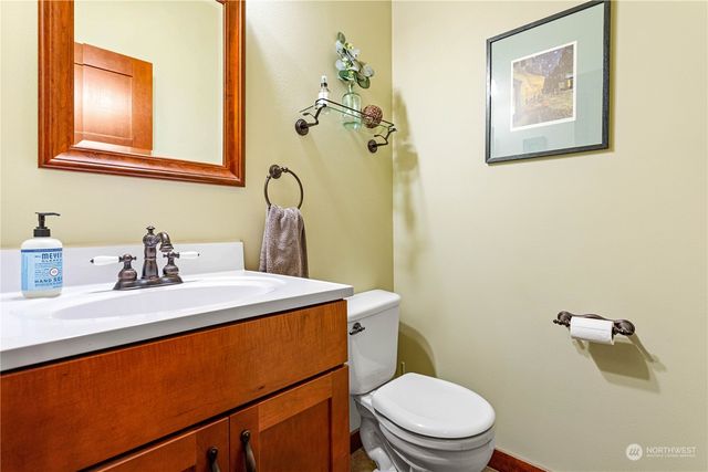 a bathroom with a sink mirror vanity and toilet