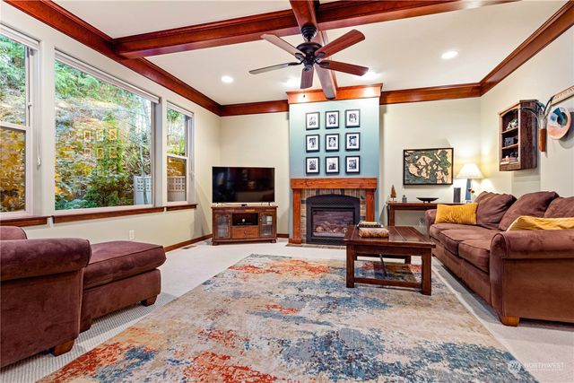 a living room with furniture a large window and a flat screen tv