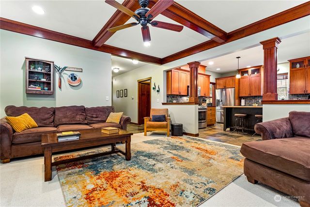 a living room with furniture and kitchen view