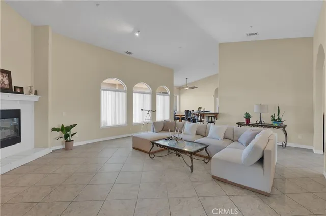 a dining hall with stainless steel appliances a dining table and chairs with wooden floor