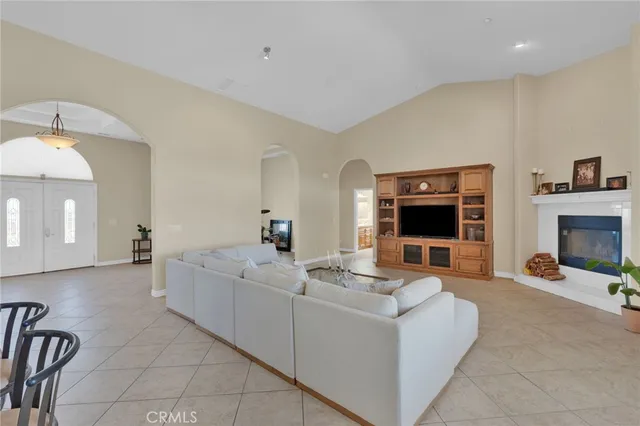 a living room with granite countertop furniture a fireplace and a flat screen tv