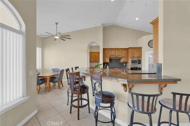 a kitchen with stainless steel appliances granite countertop a stove top oven a sink and dishwasher