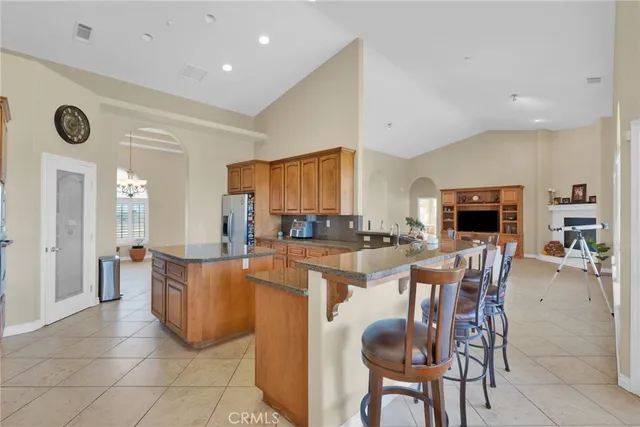 a kitchen with stainless steel appliances granite countertop a refrigerator and a sink