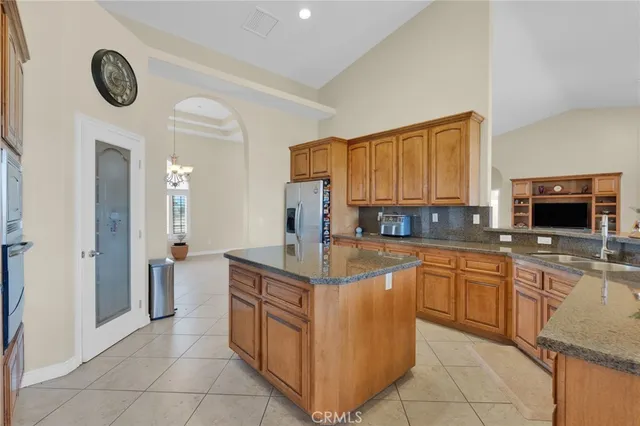 a kitchen with a stove a sink and cabinetry