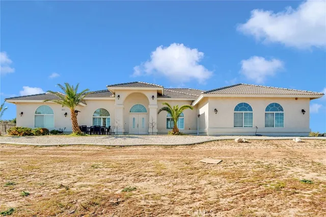a large house with a big yard and large trees