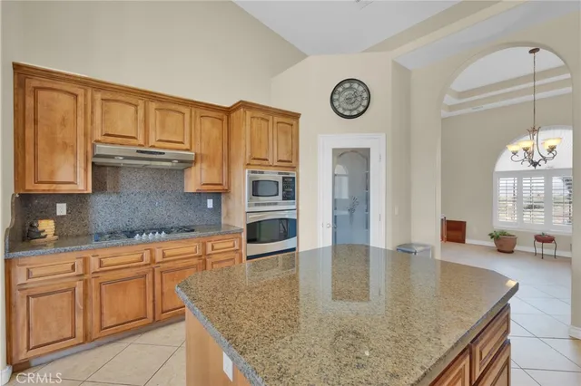 a kitchen with stainless steel appliances granite countertop a stove and a microwave
