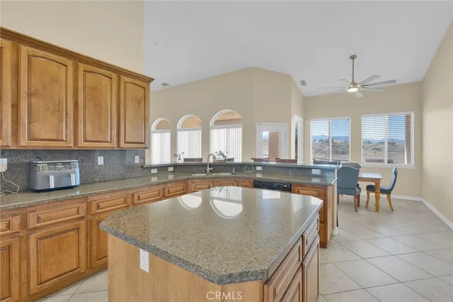 a spacious bedroom with a bed and a chandelier