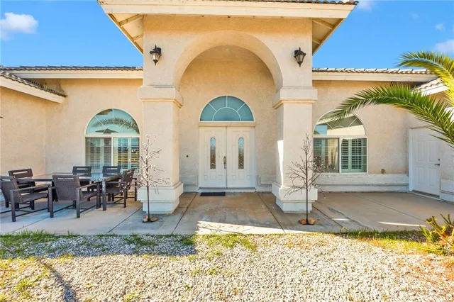 a living room with furniture a chandelier and a window