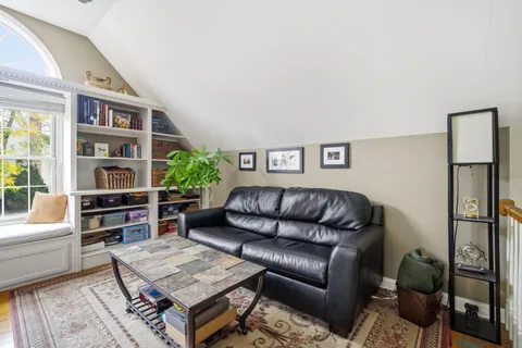 a living room with furniture and a book shelf
